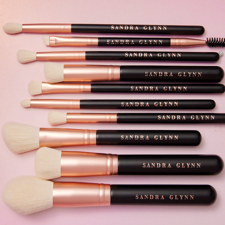 Set of Sandra Glynn makeup brushes on a pink background