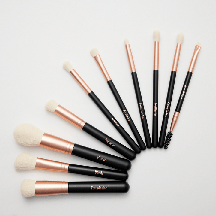 Sandra Glynn Rose Gold and black brush set labelled with brush names on a white background.